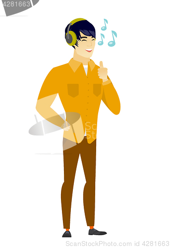 Image of Businessman listening to music in headphones.