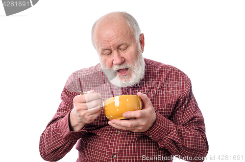 Image of Senior man eating from oragne bowl, isolated on white