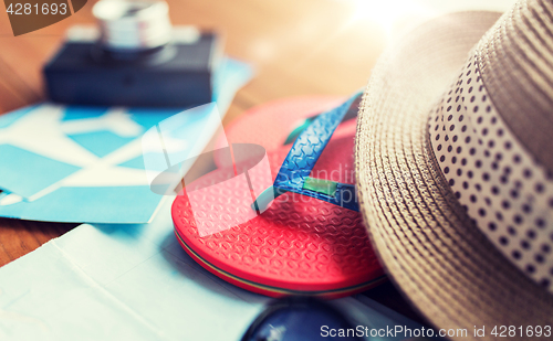 Image of close up of travel tickets, flip-flops and hat