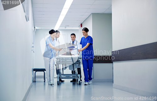 Image of medics and patient on hospital gurney at emergency