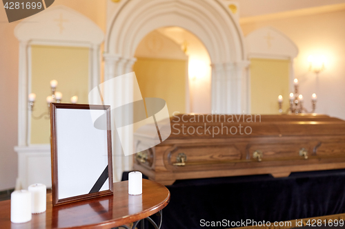 Image of photo frame and coffin at funeral in church