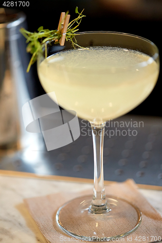 Image of glass of cocktail at bar