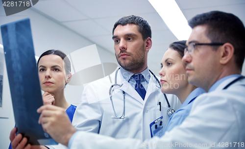 Image of group of doctors looking at x-ray scan image