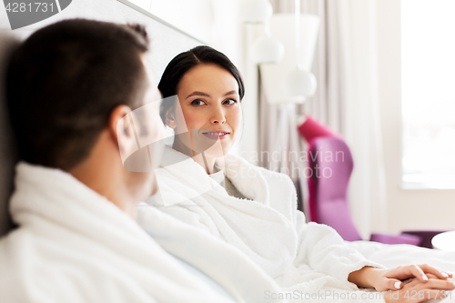 Image of happy couple in bed at home or hotel room