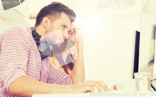 Image of stressed software developer at office