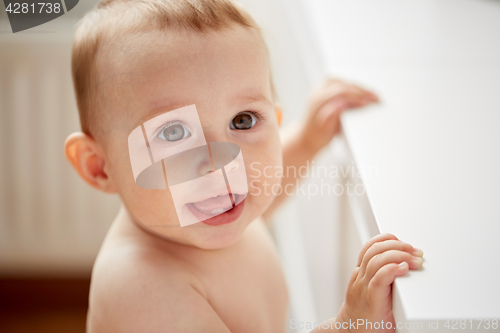 Image of happy little baby boy or girl at home