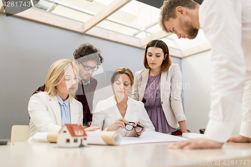 Image of business team discussing house project at office