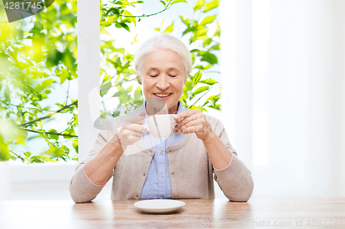 Image of happy senior woman with cup of coffee