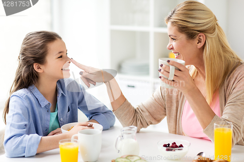 Image of happy family having breakfast at home kitchen