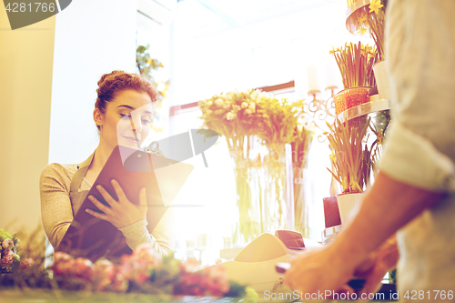 Image of florist woman and man making order at flower shop