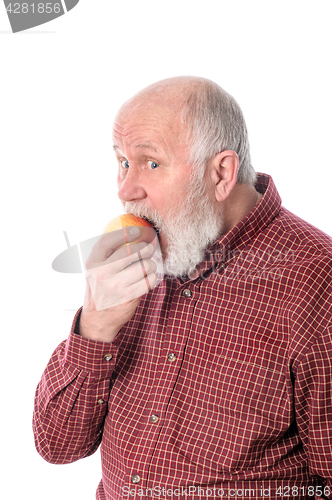 Image of Cheerfull senior man eating the apple, isolated on white