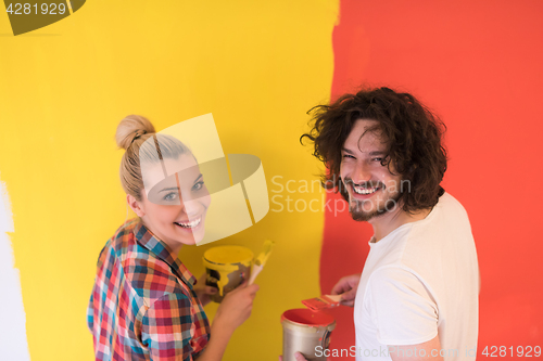 Image of couple painting interior wall