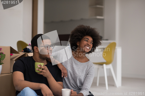 Image of African American couple relaxing in new house