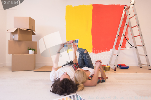 Image of Happy young couple relaxing after painting