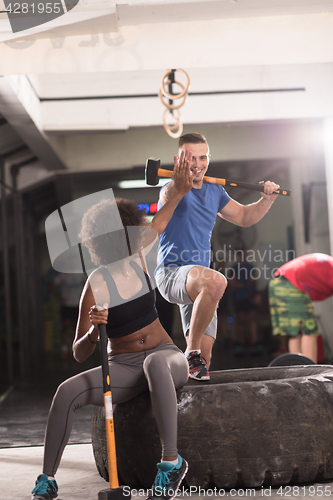 Image of multiethnic couple after workout with hammer