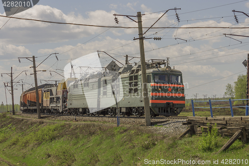 Image of Green freight train transports cargo by rail