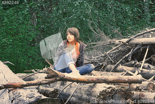 Image of Young Woman Sitting In The Forest