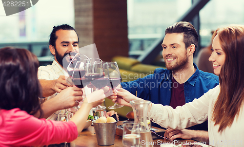 Image of friends dining and drinking wine at restaurant