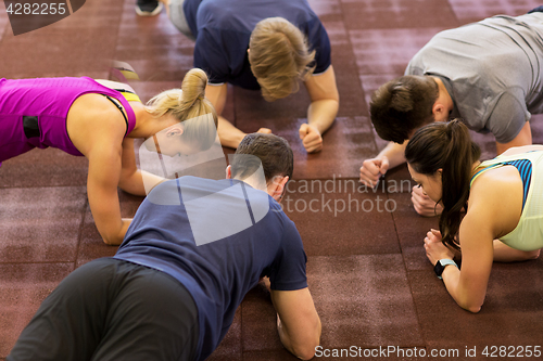 Image of group of people exercising in gym