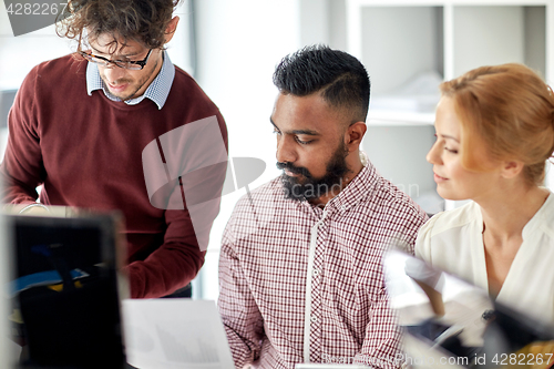 Image of business team with papers at office