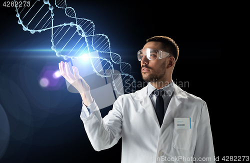Image of scientist in lab coat and safety glasses with dna