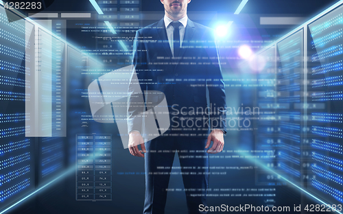 Image of businessman with coding on virtual screen