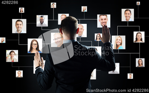 Image of businessman with virtual contact icons