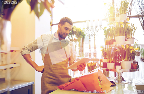 Image of man with tablet pc computer at flower shop