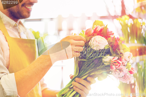 Image of close up of florist man with bunch at flower shop