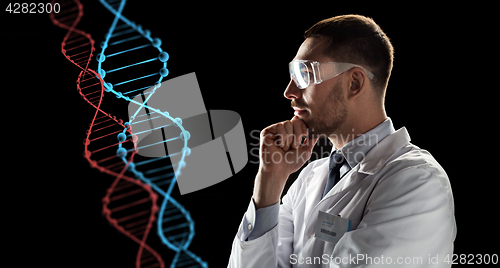 Image of scientist in goggles looking at dna molecule