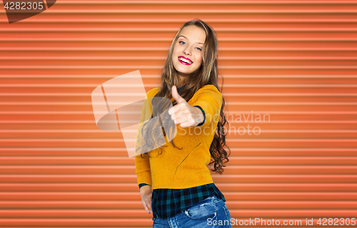 Image of happy young woman or teen girl showing thumbs up