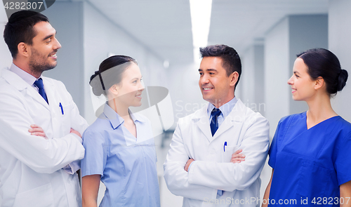 Image of happy group of medics or doctors at hospital