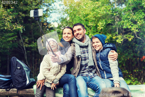 Image of happy family with backpacks hiking