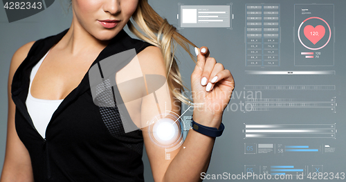 Image of close up of sporty woman with fitness tracker