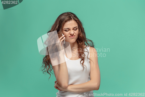 Image of The portrait of disgusted woman with mobile phone