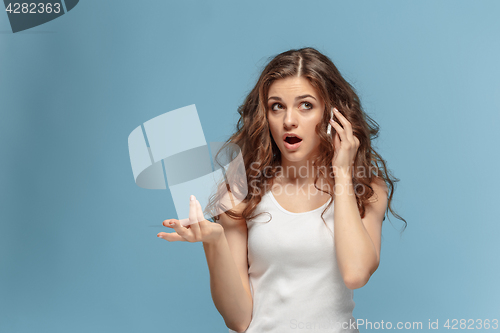 Image of The portrait of disgusted woman with mobile phone