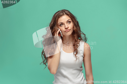 Image of The portrait of disgusted woman with mobile phone