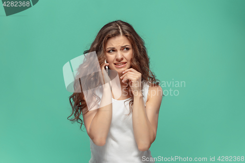 Image of The portrait of disgusted woman with mobile phone