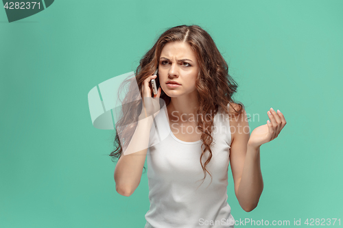 Image of The portrait of disgusted woman with mobile phone