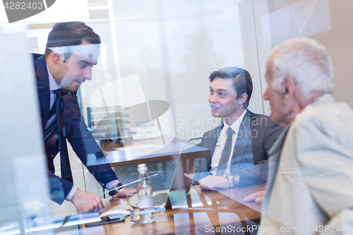 Image of Business people sitting and brainstorming at corporate meeting.