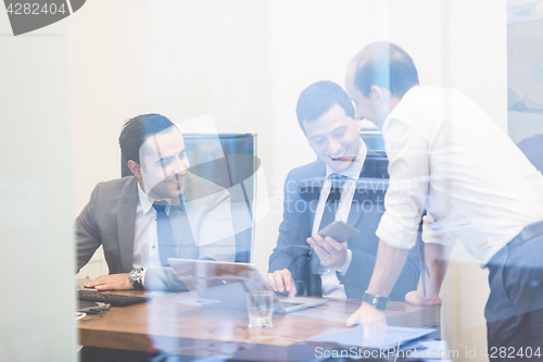 Image of Cheerful relaxed corporate businessteam working in modern office.