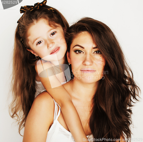 Image of young mother with little cute daughter emotional posing on white