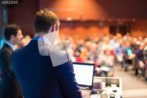 Image of Speaker at Business Conference and Presentation.