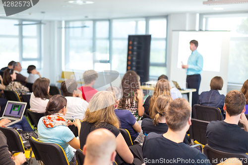 Image of Speaker giving presentation on business conference.