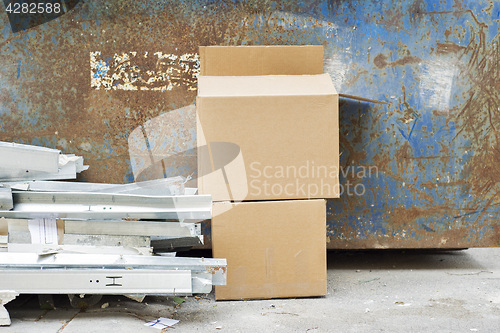 Image of Construction wastes near the metal garbage container