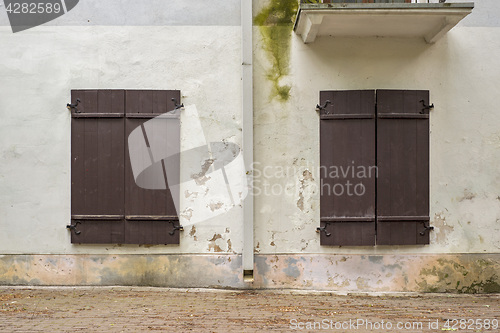 Image of abandoned grunge house with closed shutters