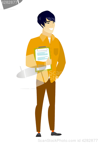 Image of Businessman holding clipboard with documents.