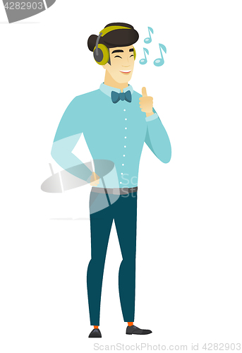 Image of Businessman listening to music in headphones.