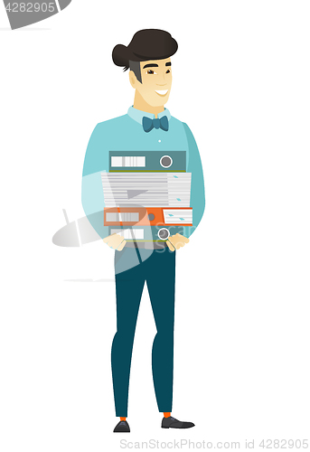 Image of Businessman holding pile of folders.