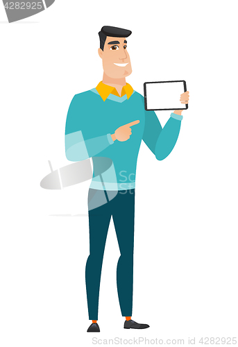 Image of Smiling businessman holding tablet computer.